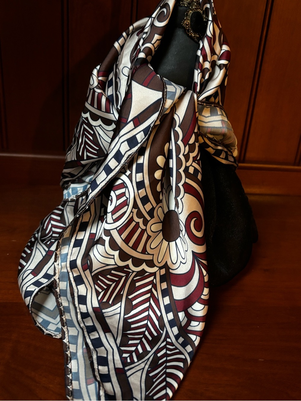 elegant brown, white, and burgundy silk scarf features an ornate floral
